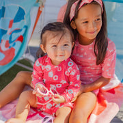 Pink one piece swimsuit with flamingo all over print, baby