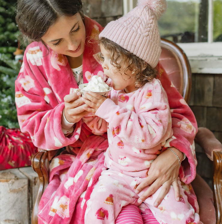 Pink knitted toque with a pompom, baby